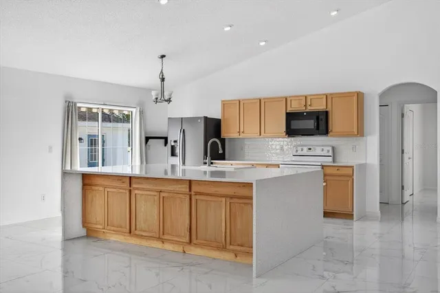 a kitchen with cabinets a sink and appliances