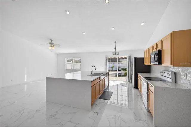 a kitchen with stainless steel appliances a sink stove and cabinets
