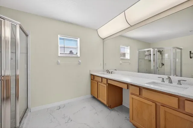 a spacious bathroom with a double vanity sink and a mirror
