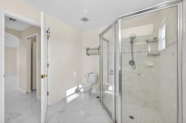 a bathroom with a glass shower door