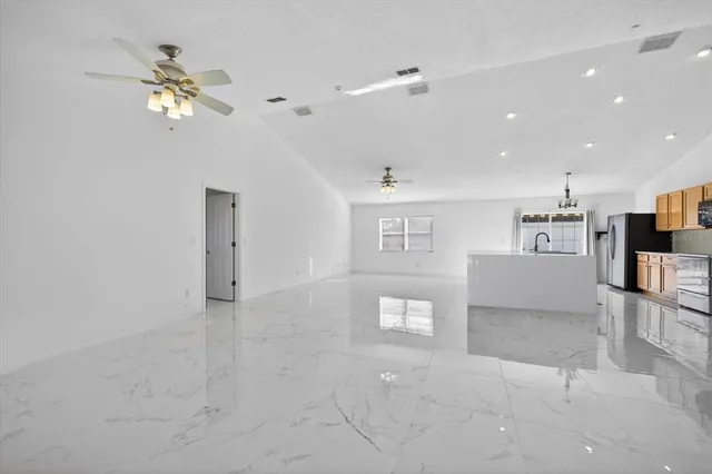 a view of a livingroom with furniture and ceiling fan