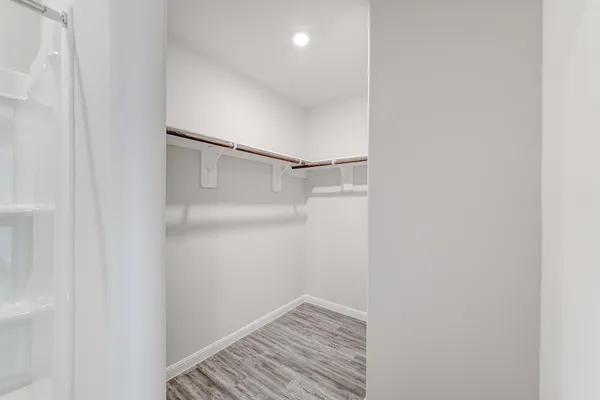 a view of hallway with wooden floor