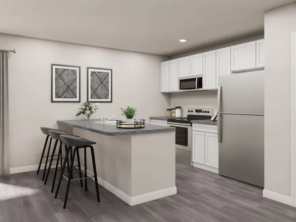 a kitchen with a sink a refrigerator a microwave and cabinets