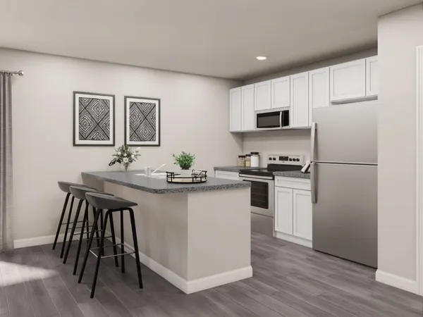 a kitchen with a sink a refrigerator a microwave and cabinets