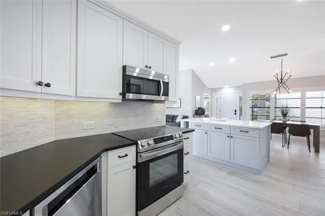 a kitchen with a sink stove and microwave