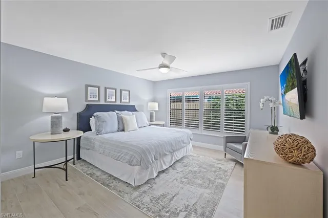 a bedroom with a bed lamps and window