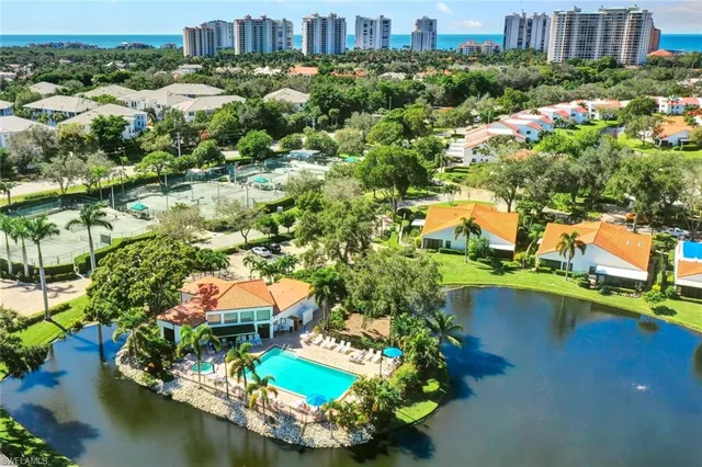 an aerial view of residential houses with outdoor space and river
