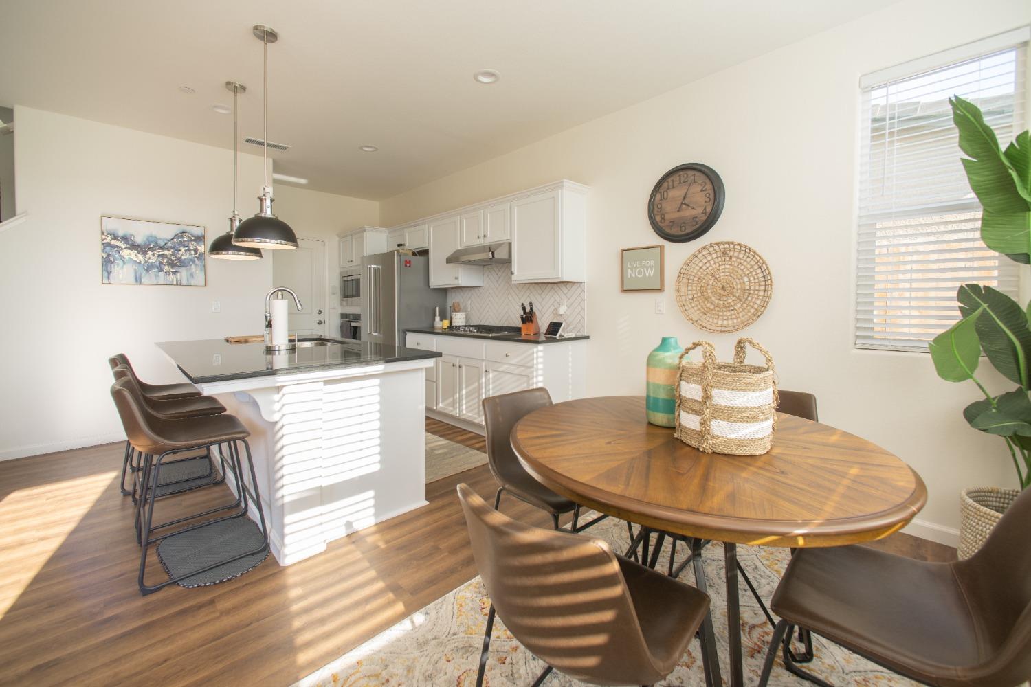 982 Moran Road West Madera, CA 93636 - Photo 4 of 9 a kitchen with a dining table and chairs