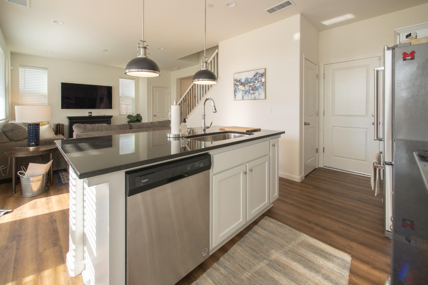 982 Moran Road West Madera, CA 93636 - Photo 5 of 9 a kitchen with granite countertop a sink and a refrigerator
