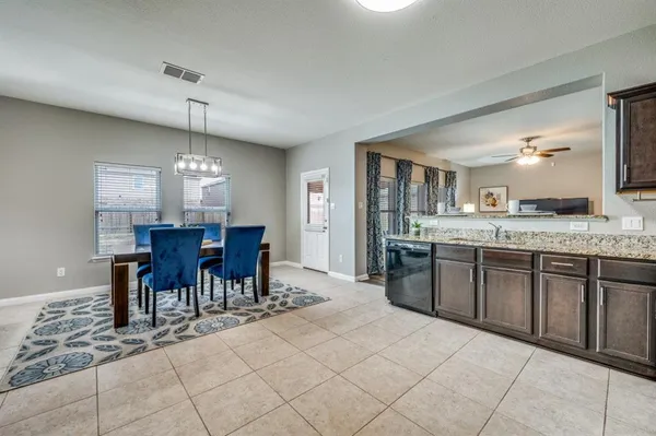 a large kitchen with a table and chairs