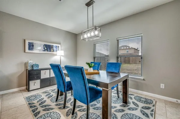 a view of a dining room with furniture and window