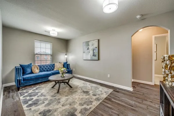 a living room with furniture and wooden floor
