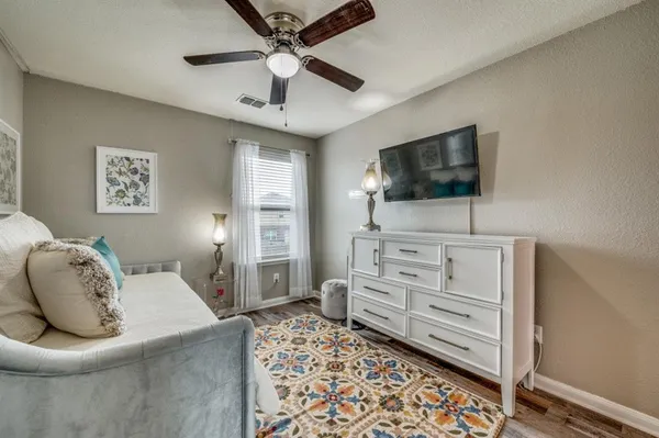 a bedroom with furniture and a flat screen tv