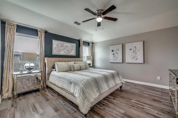 a bedroom with a large bed and a chandelier