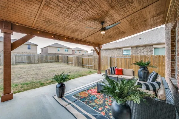 a balcony with furniture and a potted plant