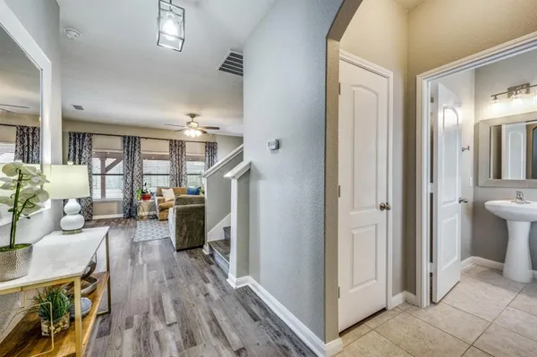 a living room with furniture and a wooden floor