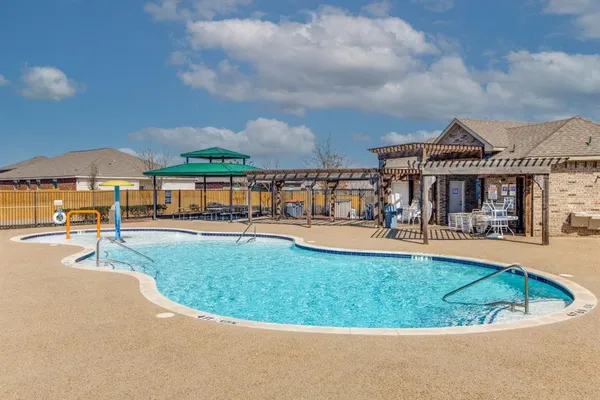 a view of a house with swimming pool and a yard