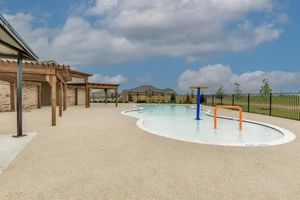 a view of swimming pool with seating area and barbeque oven