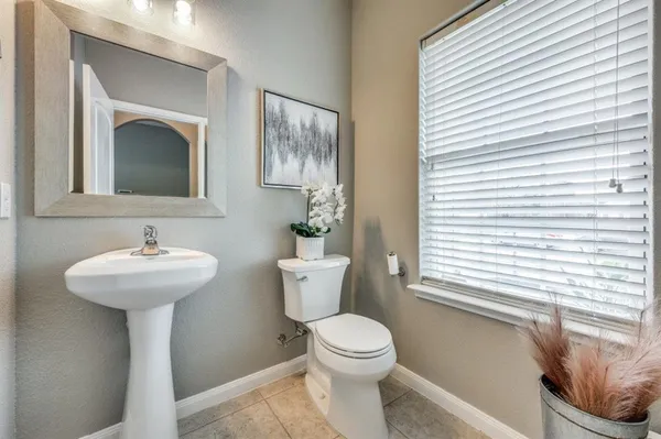 a bathroom with a toilet a sink and a mirror