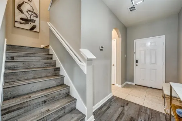 a view of entryway and hall with wooden floor