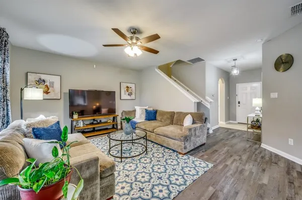 a living room with furniture and a flat screen tv