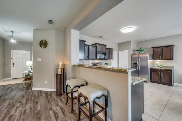 a kitchen with stainless steel appliances a refrigerator and a stove top oven