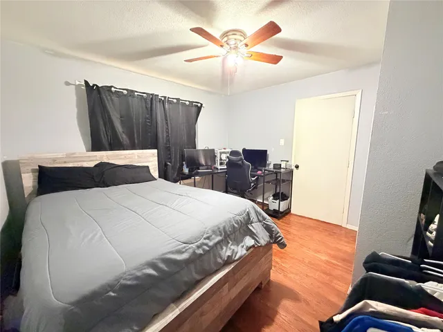 a spacious bedroom with a bed and a chandelier