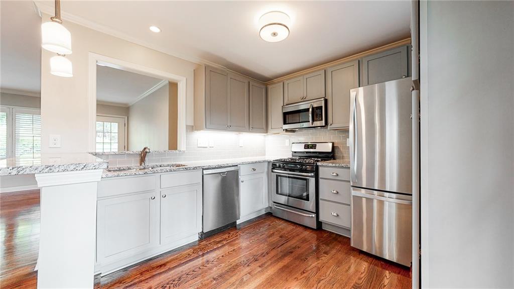 2305 Vistamont Drive Decatur, GA 30033 - Photo 11 of 28 a kitchen with granite countertop a refrigerator stove and sink