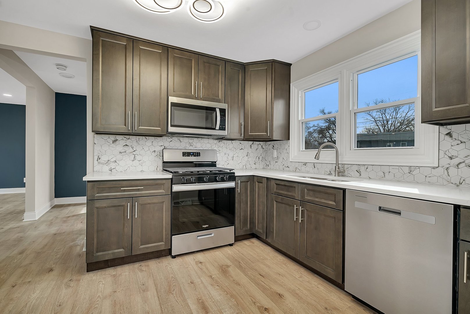 6025 Washington Street Chicago Ridge, IL 60415 - Photo 3 of 20 a kitchen with stainless steel appliances granite countertop a stove top oven a sink and dishwasher