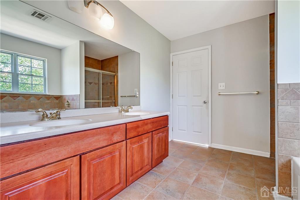12 Mapleton Road Old Bridge, NJ 08857 - Photo 18 of 22 a spacious bathroom with a double vanity sink a mirror and a shower