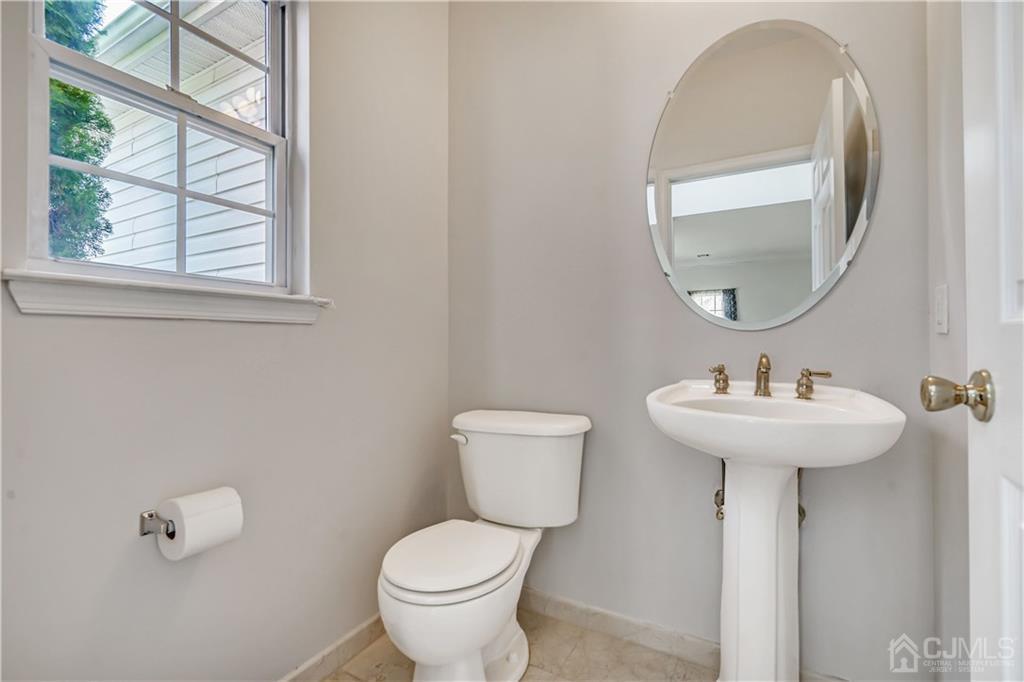 12 Mapleton Road Old Bridge, NJ 08857 - Photo 10 of 22 a bathroom with a toilet sink and mirror