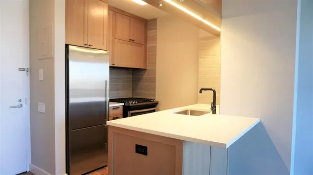 a kitchen with stainless steel appliances a refrigerator and a sink