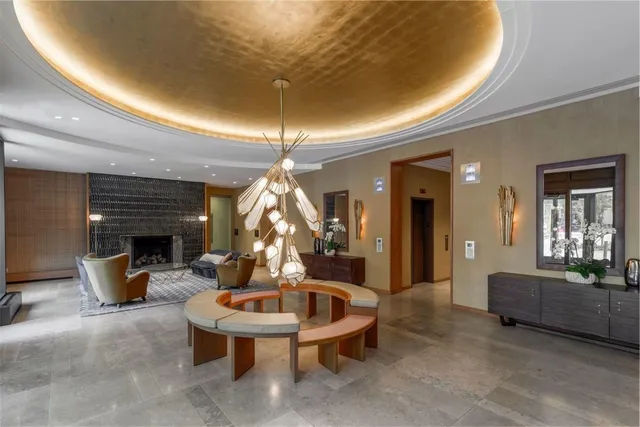 a living room with furniture and a chandelier