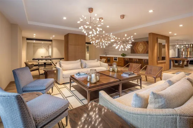 a living room with furniture and a chandelier