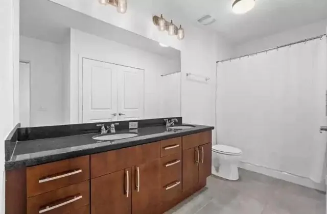 a bath room with a toilet and a sink