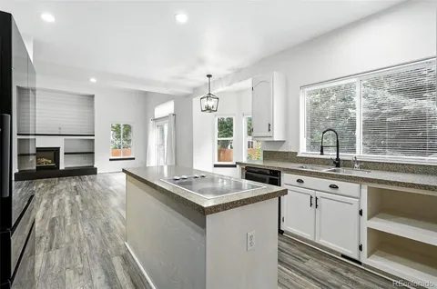 a kitchen with a sink stove and cabinets