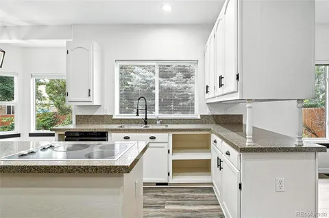 a kitchen with granite countertop a sink and a window