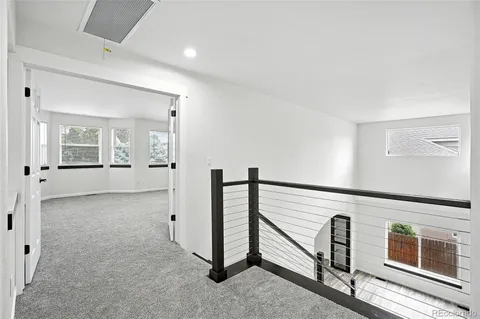 view of an empty room with wooden floor and windows