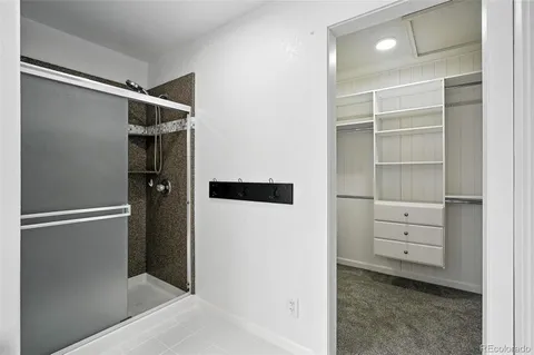 a view of walk in closet with empty racks