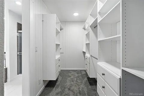a bathroom with a bathtub and a walk in closet
