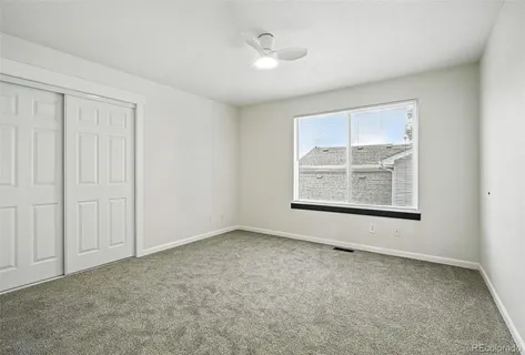 an empty room with windows and closet