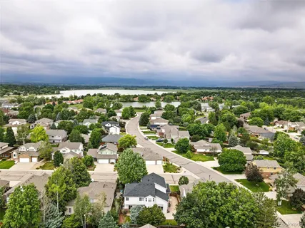 an aerial view of a house with garden space and street view