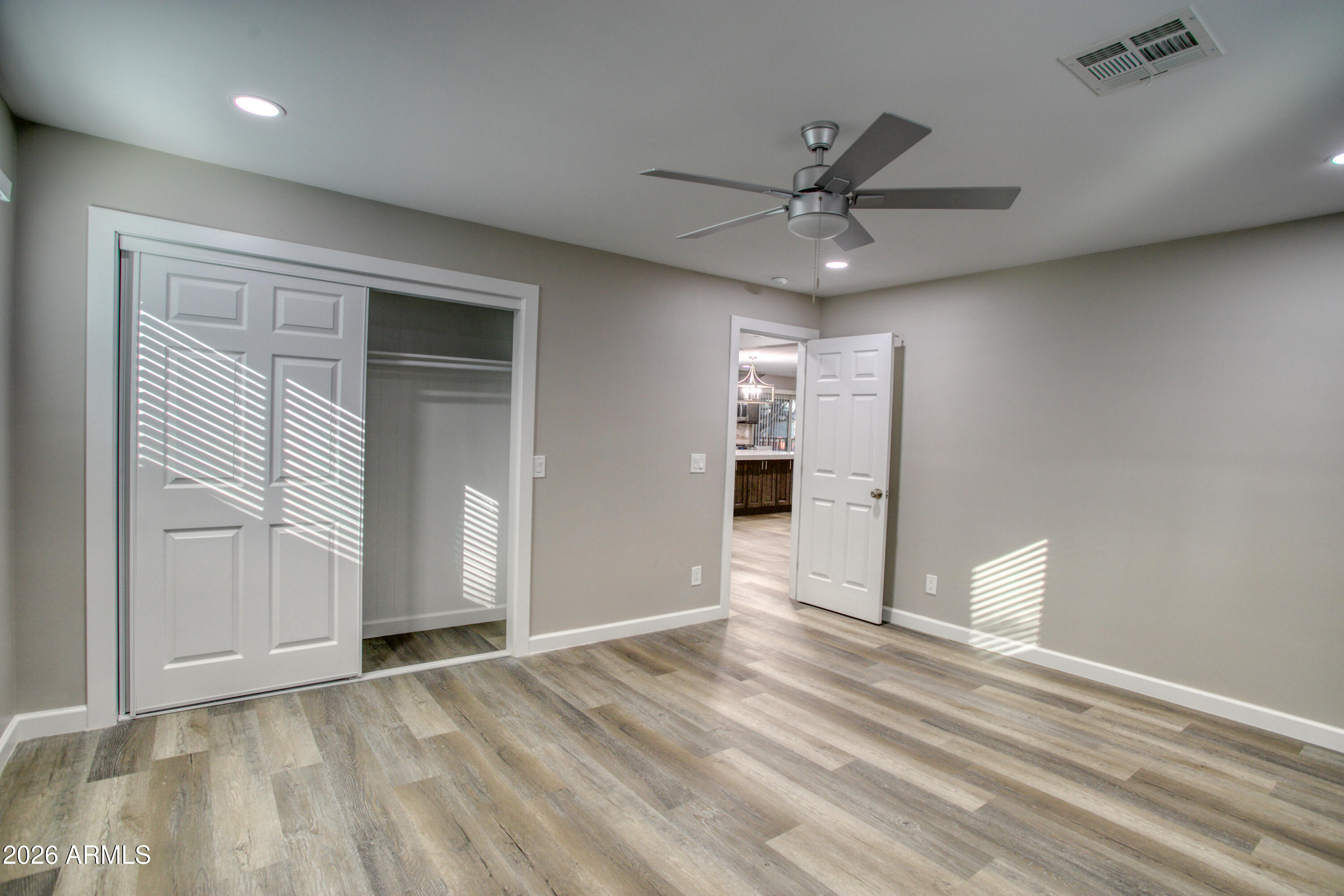 5298 Pine Dawn Road Lakeside, AZ 85929 - Photo 11 of 19 an empty space with wooden floor and a ceiling fan