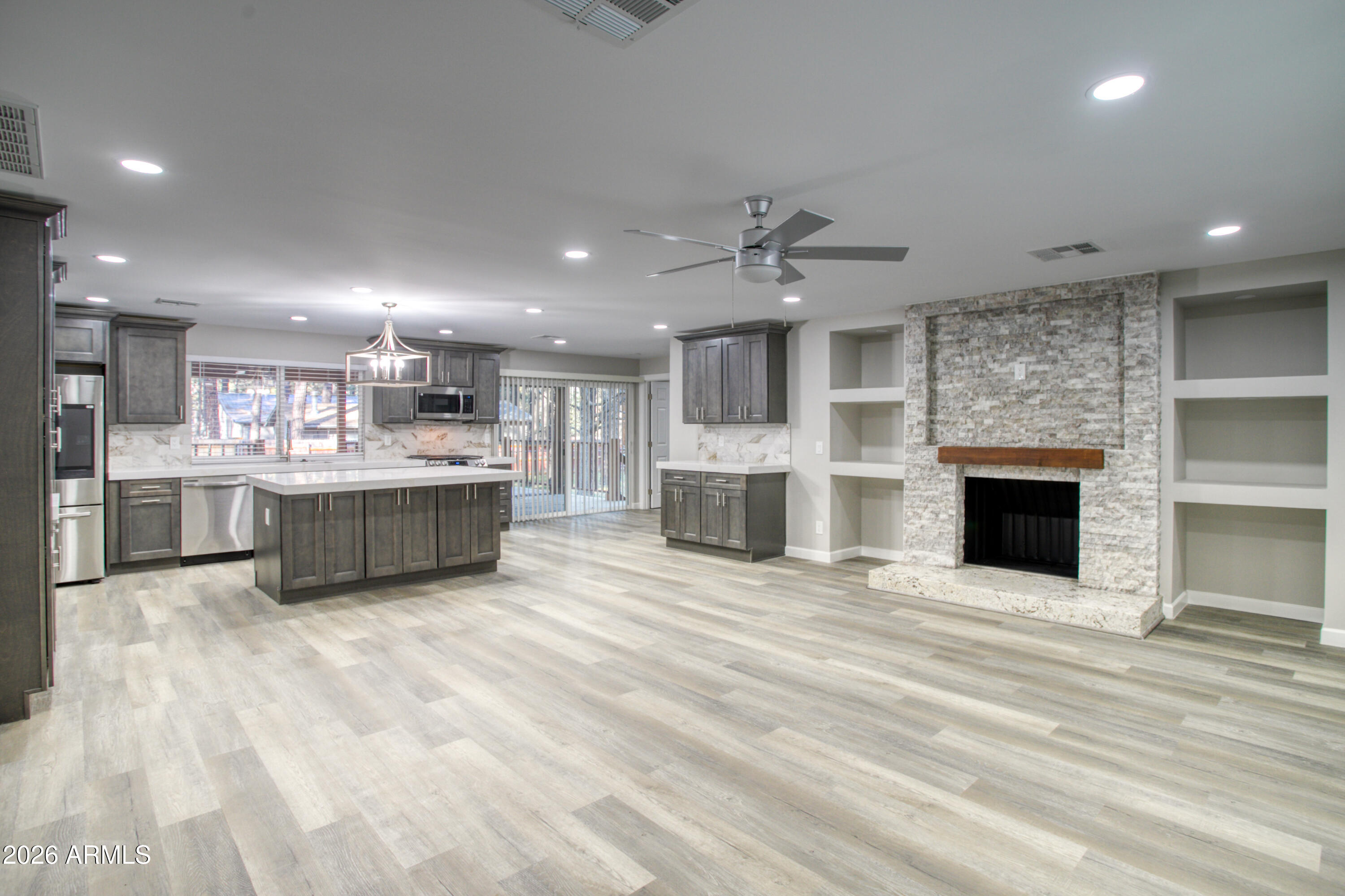 5298 Pine Dawn Road Lakeside, AZ 85929 - Photo 5 of 19 a large white kitchen with stainless steel appliances kitchen island a large island in the center