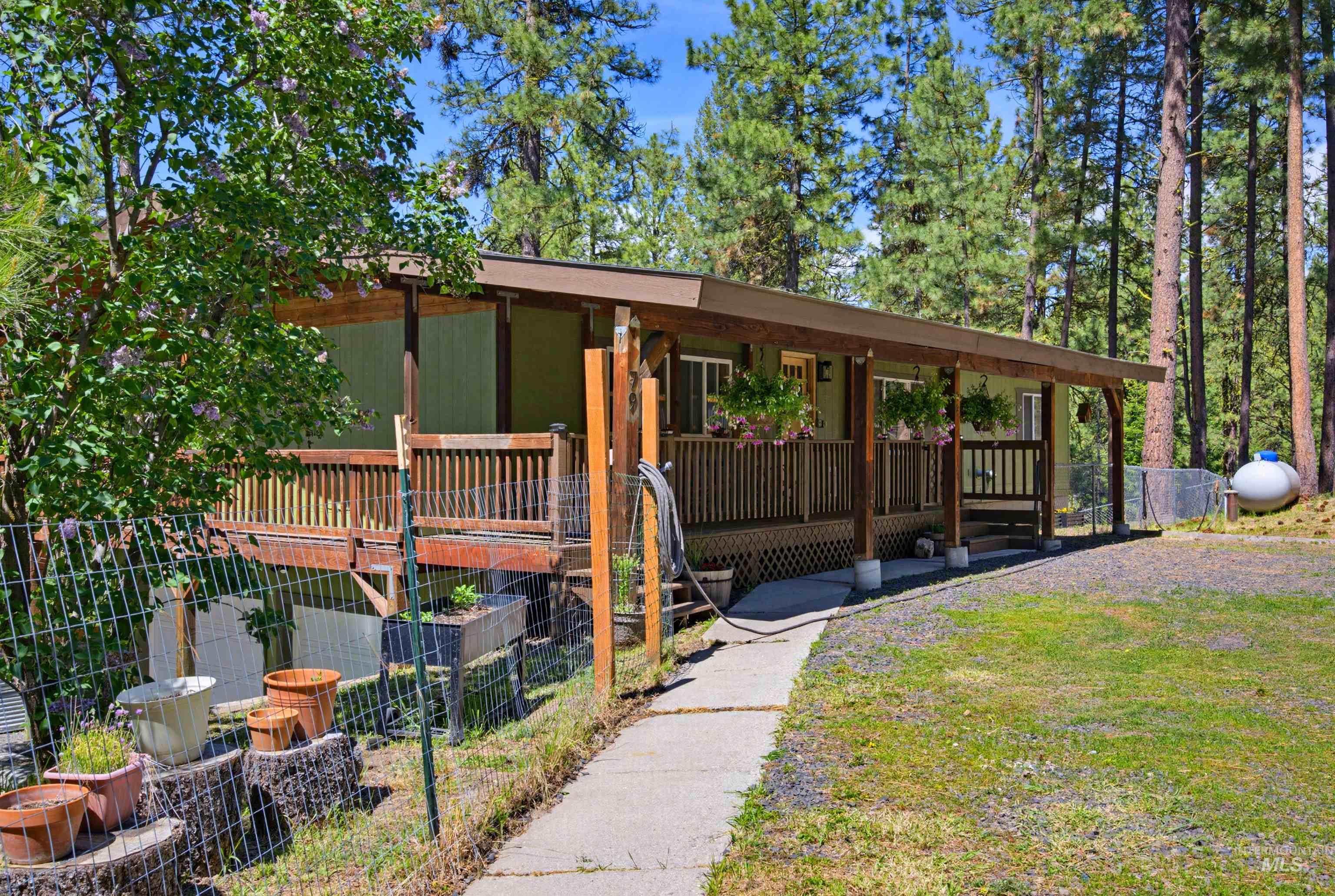 79 Sunset Loop Cascade, ID 83611 - Photo 35 of 44 Exterior featuring a covered wooden porch with railings, light green siding, and exposed structural beams