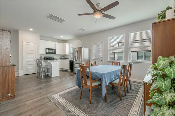 a view of a dining room with furniture and wooden floor