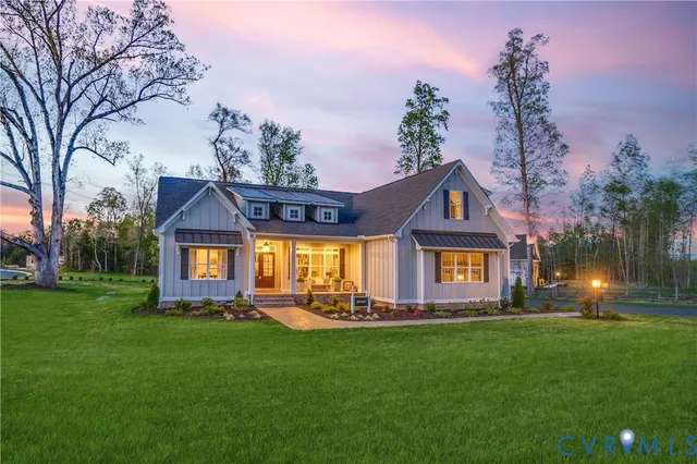 a front view of a house with a garden and plants