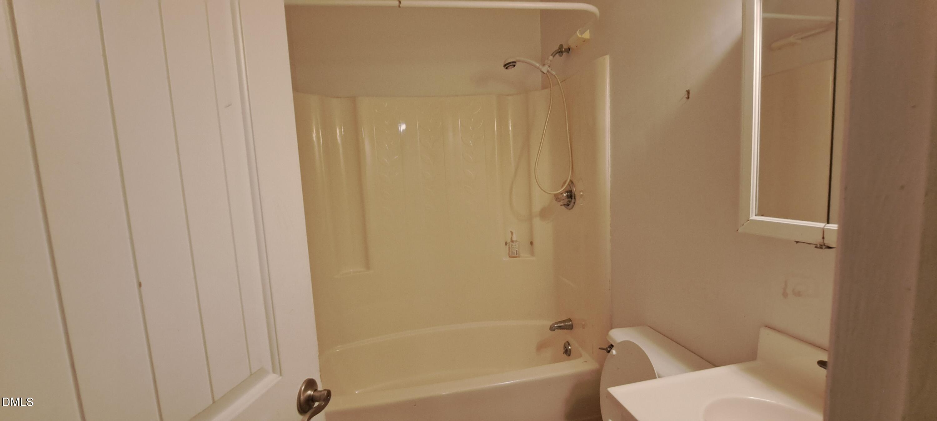 2501 St Christopher Circle Southwest, Unit 6 Wilson, NC 27893 - Photo 7 of 10 a bathroom with a sink a toilet and shower