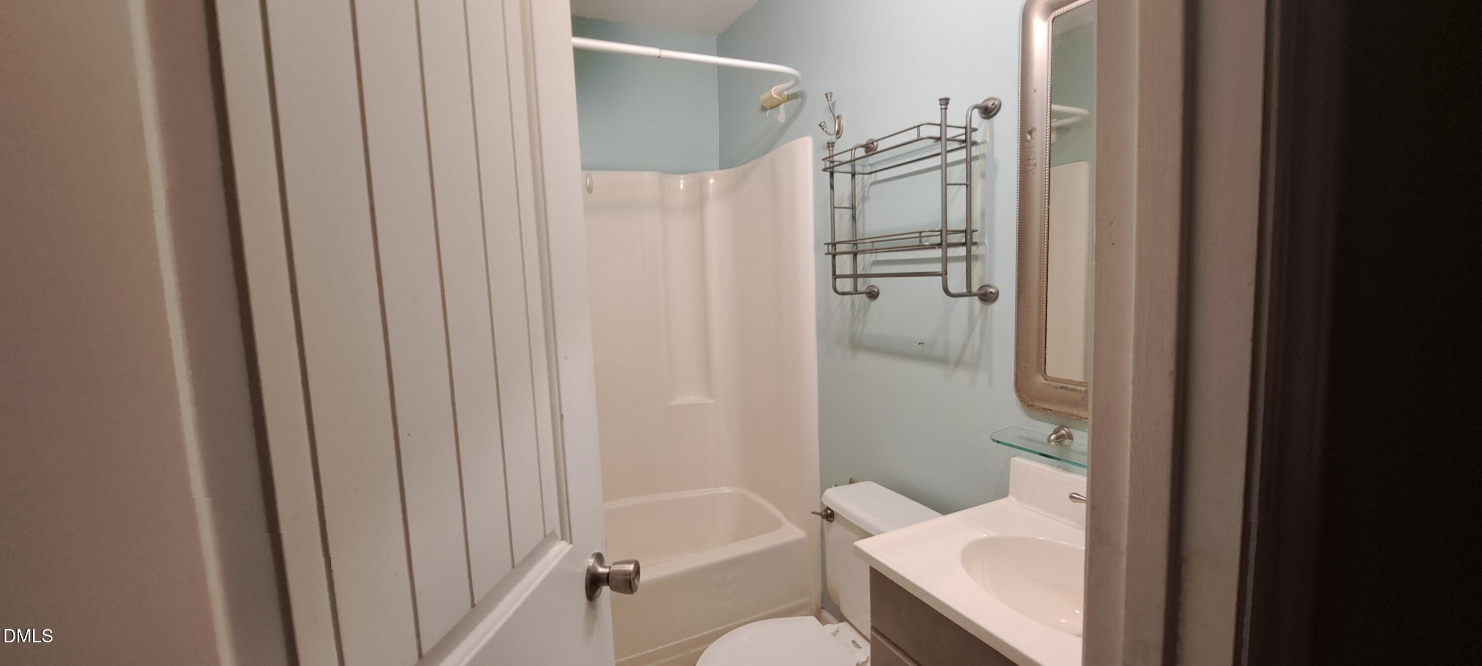 2501 St Christopher Circle Southwest, Unit 6 Wilson, NC 27893 - Photo 8 of 10 a bathroom with a shower and a toilet