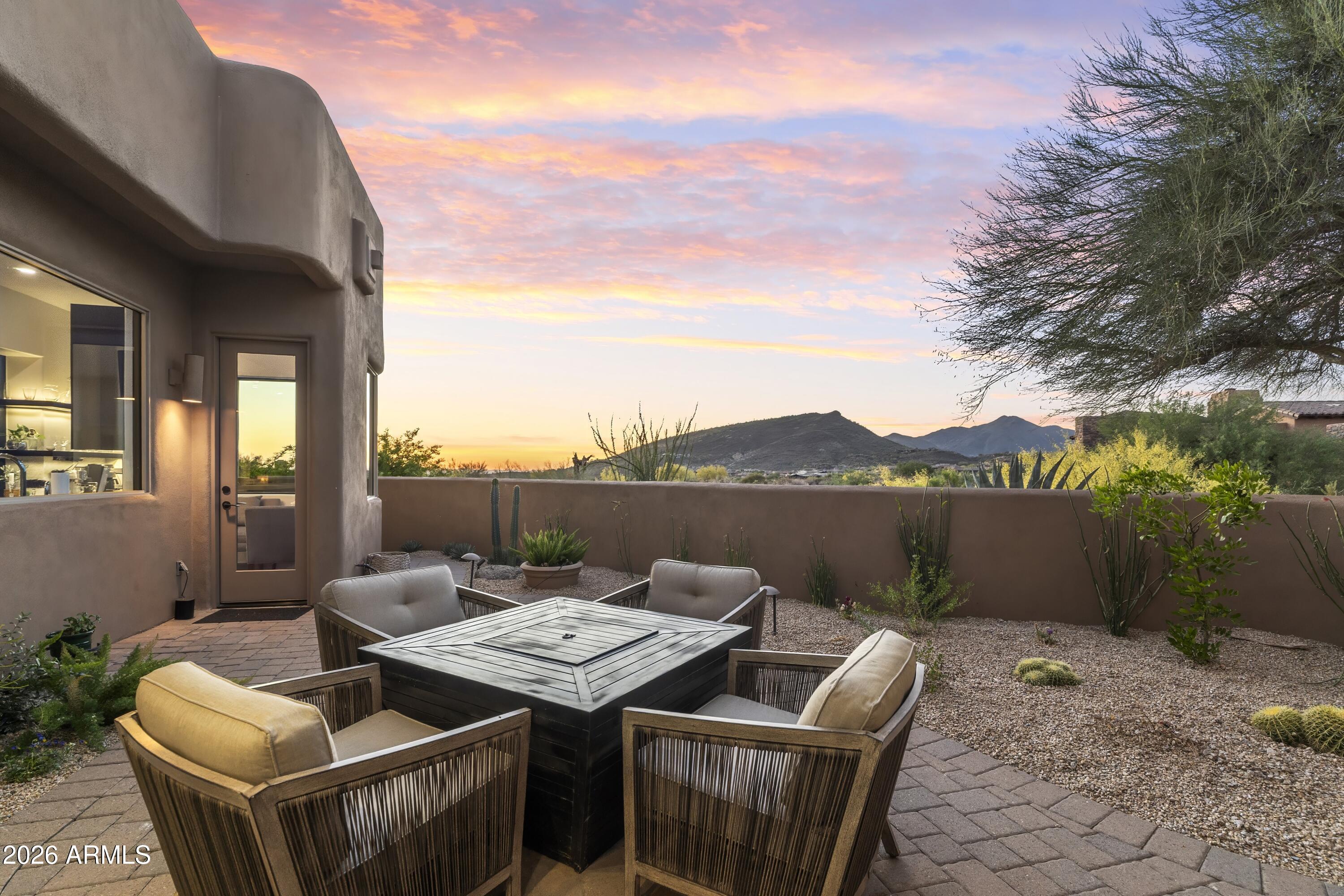 10046 East Hidden Valley Road Scottsdale, AZ 85262 - Photo 59 of 64 a terrace with outdoor seating and city view